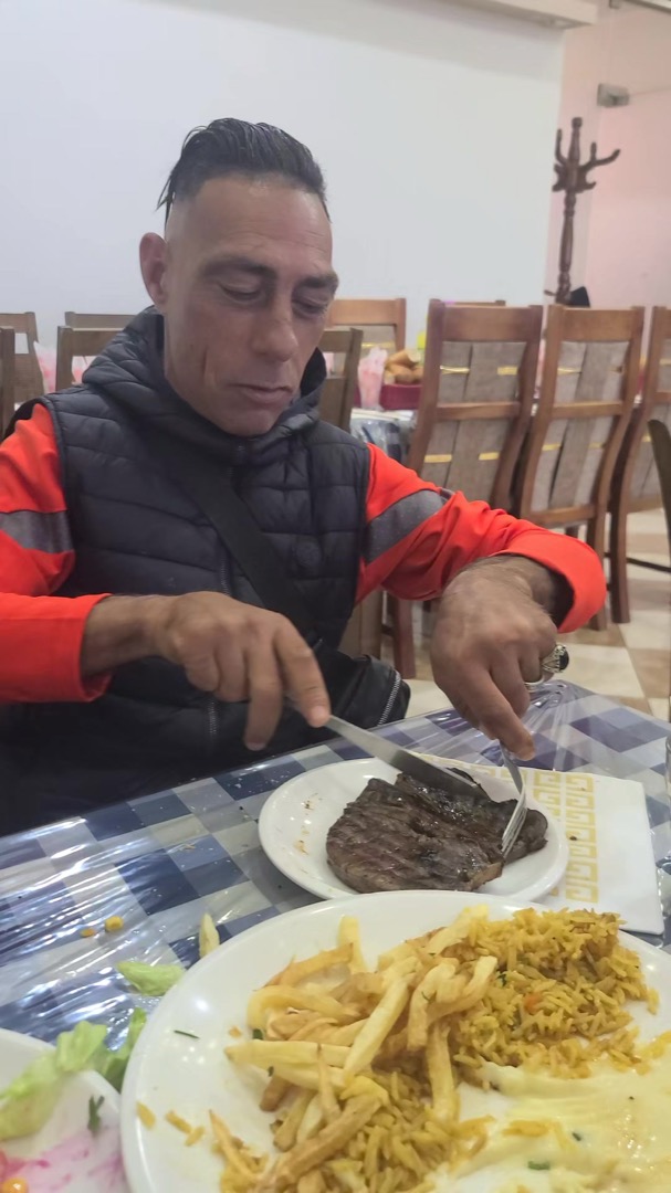 Choucha eating a steak in a restaurant